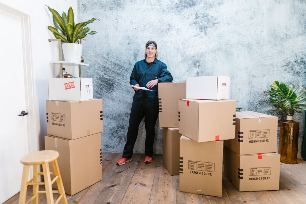 A Man Standing Near Cardboard Boxes